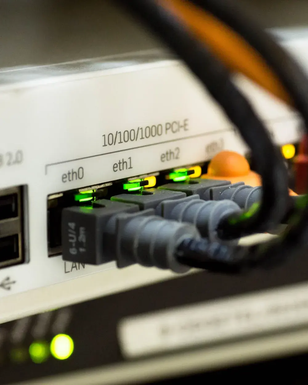 Network cables plugged into the ethernet ports of a router