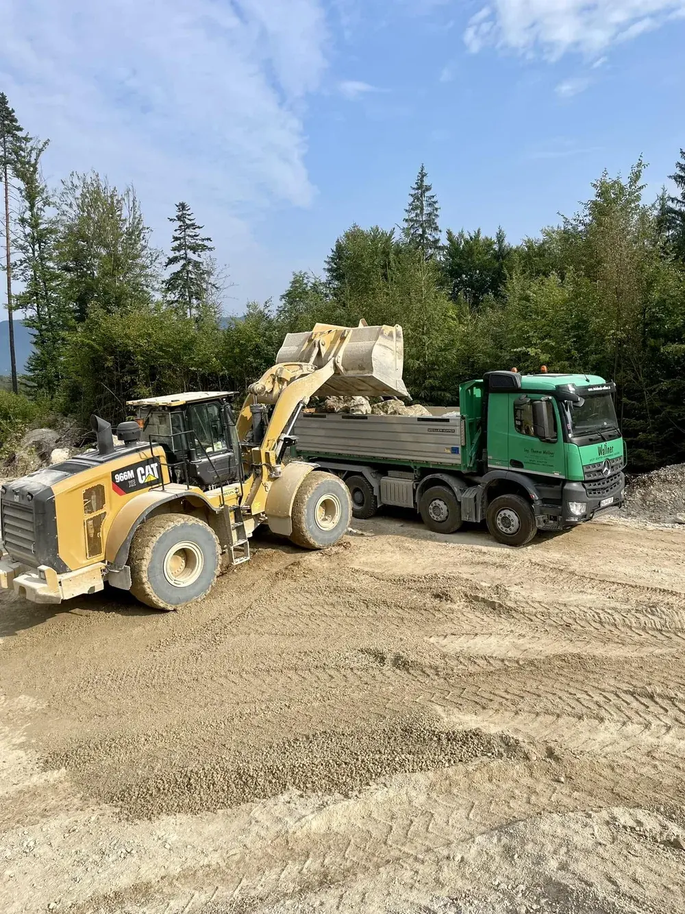 Wheel loader loading a tipper truck with gravel at the quarry